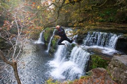 Jumping off a waterfall during canyoning Jumping off a waterfall during canyoning